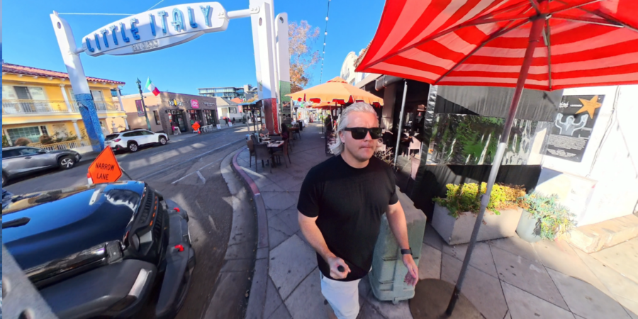 Wesley Guest walking near the Little Italy sign in San Diego